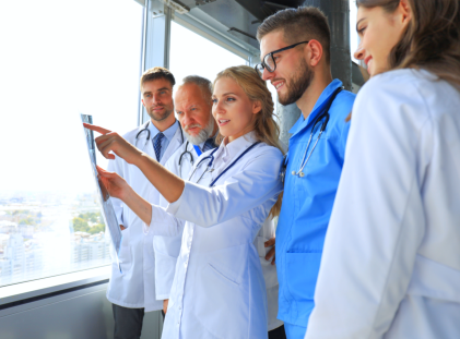 one doctor pointing the x-ray resut
